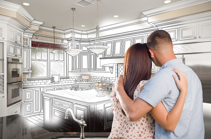 Couple looking into an imaginary kitchen they would like to build.