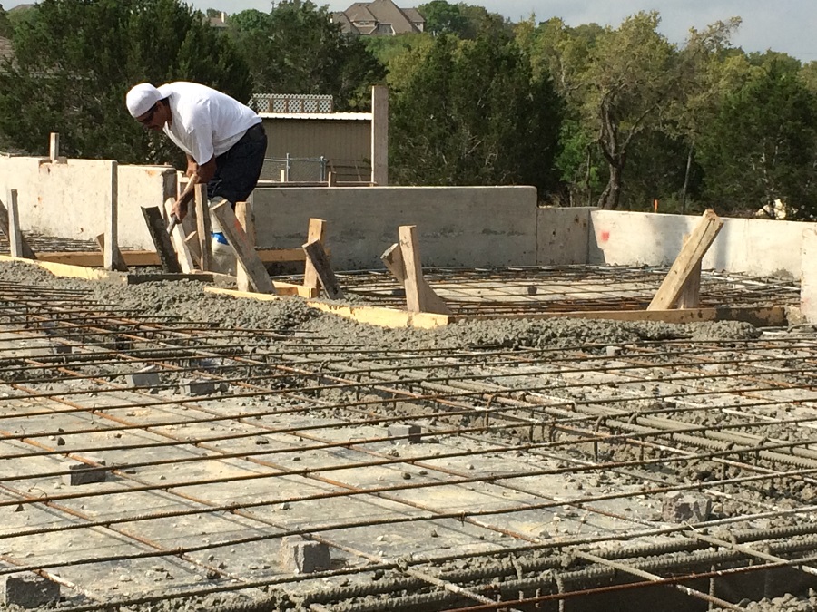 Man working on a concrete foundation with rebar.