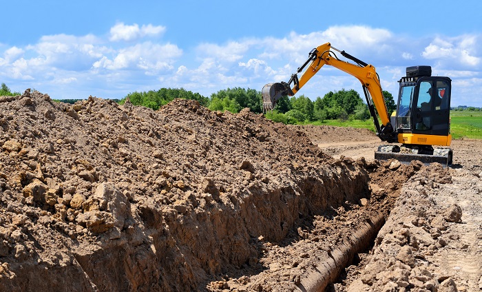Excavator digging a trench.