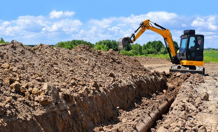 Excavator digging a trench.