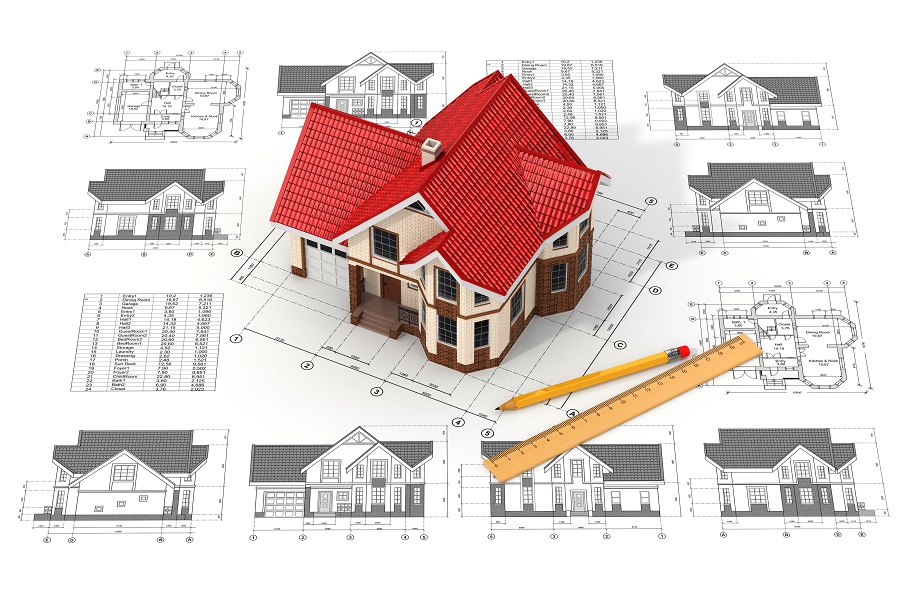 Scale model home on top of a set of its own blueprints.