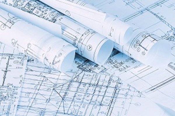 Several sets of blueprints, some flat, some rolled up.